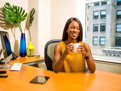 woman-holding-white-ceramic-mug-at-desk-2422287